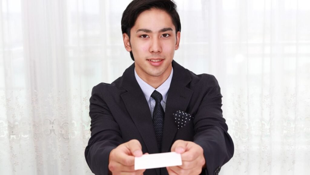 a man handing out his japanese business card