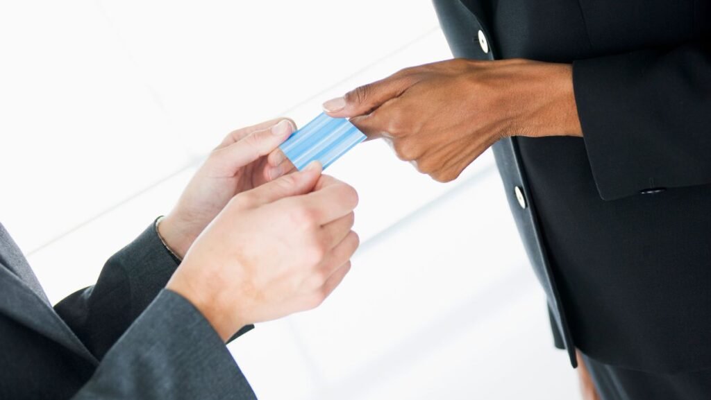 two people exchanging japanese business cards