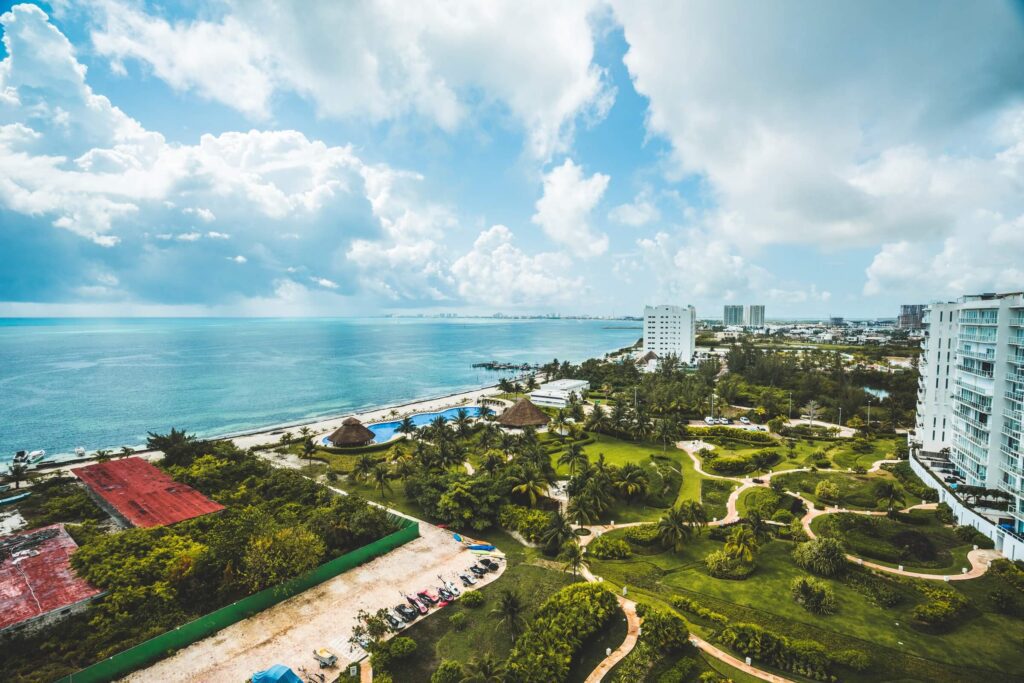An aerial view of the gardens of Cancun in front of the hotels at the coast.