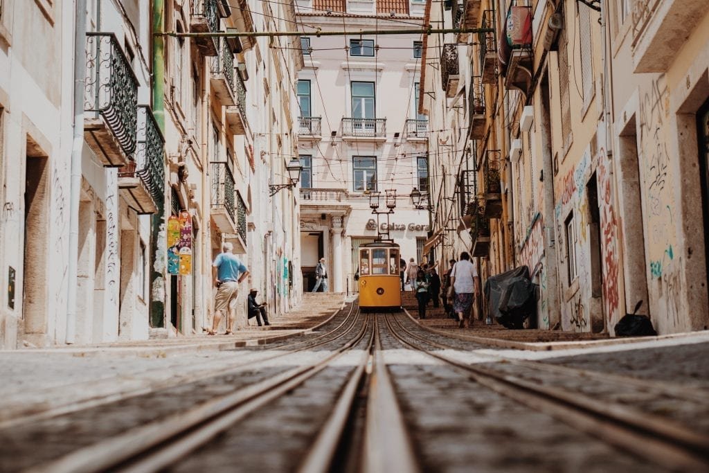 Study in Lisbon Portugal-a yellow tram is going through the city of Lisbon in Portugal