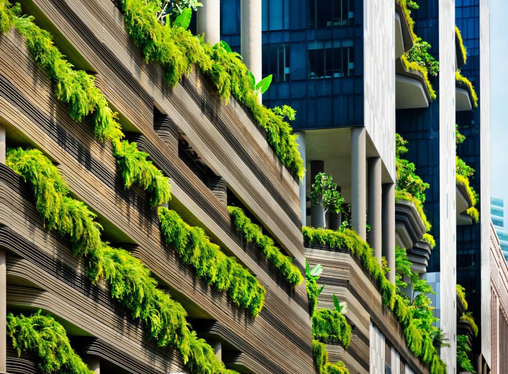 Close-up of a building in Singapore blending greenery with modern skyscraper design, highlighting the city’s eco-urban architecture.