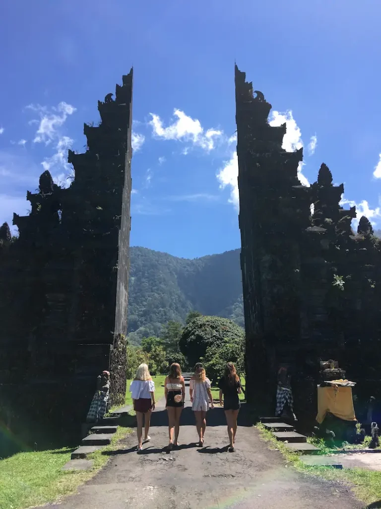 Four girls visiting a traditional gate in Bali after classes
