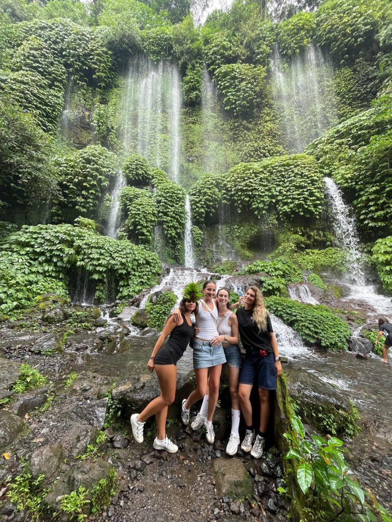 Emma and her friends exploring a waterfall in Bali, Indonesia