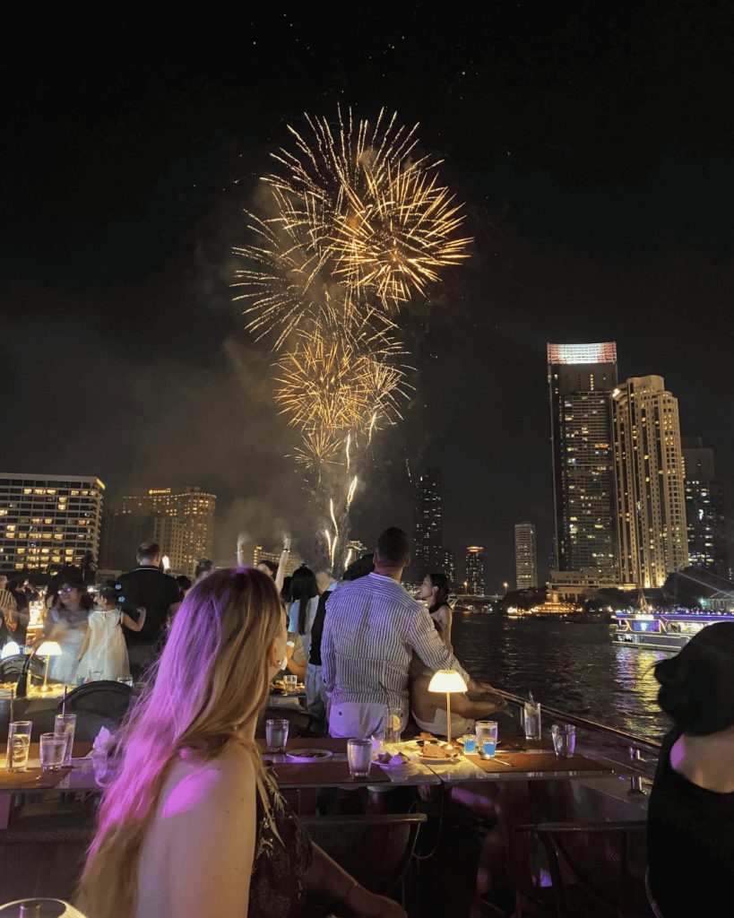 Camille, exchange student in Bangkok on a rooftop looking at fireworks