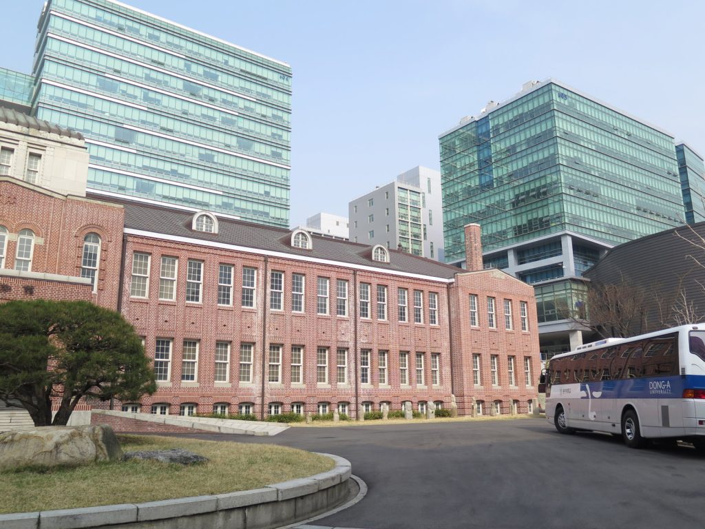 Brick campus building at Dong-A University in South Korea, showcasing traditional architecture with a clean, academic setting.