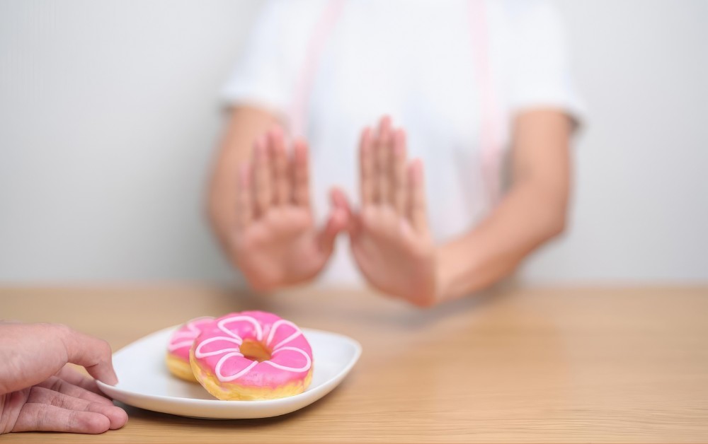 Image of someone refusing donuts